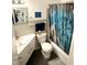 Updated bathroom features a modern sink and tub with decorative shower curtain at 2615 Alexandria Pike, Anderson, IN 46012