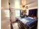 Well-lit bedroom offers a ceiling fan, large window and comfortable furnishings at 2615 Alexandria Pike, Anderson, IN 46012