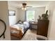 This bedroom features a bed, desk, ceiling fan, and a sunny window at 2615 Alexandria Pike, Anderson, IN 46012