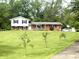 Charming two-story home with brick accents, white siding and black shutters on a large lawn at 2615 Alexandria Pike, Anderson, IN 46012