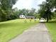 Charming two-story home with brick accents, white siding and black shutters on a large lawn at 2615 Alexandria Pike, Anderson, IN 46012