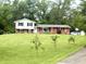 Charming two-story home with brick accents, white siding and black shutters on a large lawn at 2615 Alexandria Pike, Anderson, IN 46012