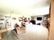 Open living room featuring plush carpeting, comfortable seating, piano and view to kitchen at 2615 Alexandria Pike, Anderson, IN 46012