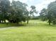 Lush green yard with mature trees offers plenty of space for outdoor activities at 2615 Alexandria Pike, Anderson, IN 46012