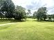 Lush green yard with mature trees offers plenty of space for outdoor activities at 2615 Alexandria Pike, Anderson, IN 46012