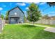 Large backyard with a manicured lawn, a patio seating area, and plenty of space for outdoor activities at 2720 Guilford Ave, Indianapolis, IN 46205