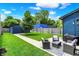 Spacious backyard with a well-manicured lawn, a paved walkway, and an inviting outdoor seating area at 2720 Guilford Ave, Indianapolis, IN 46205
