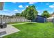 Well-maintained backyard with a lush lawn, mature tree, and a patio area, ideal for outdoor relaxation at 2720 Guilford Ave, Indianapolis, IN 46205