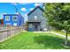 Beautifully landscaped backyard with lush lawn, fenced perimeter, and an inviting patio area for relaxation at 2720 Guilford Ave, Indianapolis, IN 46205