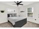 Comfortable bedroom featuring a ceiling fan and natural light from the large window at 2720 Guilford Ave, Indianapolis, IN 46205