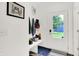 Entryway featuring a bench with storage, coat hooks, and a view of the front yard through the door at 2720 Guilford Ave, Indianapolis, IN 46205