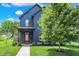 Charming two-story home with blue siding, a red door, and a well-manicured lawn, offering great curb appeal at 2720 Guilford Ave, Indianapolis, IN 46205
