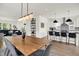 Bright, open kitchen with white cabinetry, stainless steel appliances, and an island with bar seating, ideal for modern living at 2720 Guilford Ave, Indianapolis, IN 46205