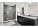 Modern bathroom with double vanity, sleek fixtures, and walk-in shower with glass door at 2720 Guilford Ave, Indianapolis, IN 46205