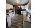 Functional kitchen featuring white cabinetry, wood-look floors, and essential appliances for a comfortable living experience at 2824 Brown St, Anderson, IN 46016