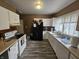 Functional kitchen featuring white cabinetry, wood-look floors, and essential appliances for a comfortable living experience at 2824 Brown St, Anderson, IN 46016