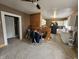 Combined living and dining space featuring carpeted floors, a partial wood wall, and connecting kitchen at 2824 Brown St, Anderson, IN 46016