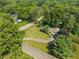 An aerial view displays a home with a circular driveway, a lawn, and mature trees at 2906 E 65Th St, Indianapolis, IN 46220