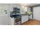 This remodeled kitchen features stainless steel appliances, granite countertops, and stylish backsplash at 2906 E 65Th St, Indianapolis, IN 46220