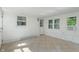 White sunroom featuring tiled flooring, an exterior door and multiple windows at 2906 E 65Th St, Indianapolis, IN 46220