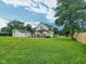 Large backyard with a deck, a detached garage, and plenty of green space at 3015 Mckinley Ave, Columbus, IN 47201