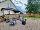 A cozy backyard patio featuring Adirondack chairs, a fire pit, and a wooden deck at 3015 Mckinley Ave, Columbus, IN 47201