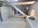 Unfinished basement with painted walls and ceiling, and stairs to upper level at 3015 Mckinley Ave, Columbus, IN 47201