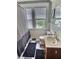 Cozy bathroom features a black and white checkerboard floor, a window, and a striped shower curtain at 3015 Mckinley Ave, Columbus, IN 47201