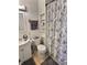 Bathroom with vanity, toilet, decorative shower curtain, and built-in shelving at 3015 Mckinley Ave, Columbus, IN 47201