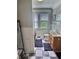 Cozy bathroom features a black and white checkerboard floor, a window, and a striped shower curtain at 3015 Mckinley Ave, Columbus, IN 47201