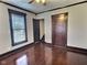 Bedroom with hardwood floors, natural light, and dark wood trim at 3015 Mckinley Ave, Columbus, IN 47201