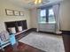 Bedroom featuring a gray rug, ceiling fan, a window with curtains, and a built-in shelving unit at 3015 Mckinley Ave, Columbus, IN 47201