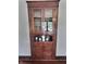 Charming corner cabinet with glass doors and decorative details, adding character to the dining area at 3015 Mckinley Ave, Columbus, IN 47201