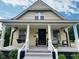 Charming home featuring a covered front porch with decorative columns and a cozy porch swing at 3015 Mckinley Ave, Columbus, IN 47201