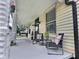 Covered front porch with comfortable seating, perfect for relaxing and enjoying the outdoors at 3015 Mckinley Ave, Columbus, IN 47201