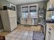 Well-lit kitchen with white cabinetry, stainless steel appliances, and a window overlooking the neighborhood at 3015 Mckinley Ave, Columbus, IN 47201