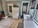 Kitchen with a white refrigerator, stainless steel microwave, and a sink below a bright window at 3015 Mckinley Ave, Columbus, IN 47201