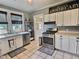 Bright kitchen featuring white cabinets, stainless steel appliances, and a decorative Apothecary sign at 3015 Mckinley Ave, Columbus, IN 47201
