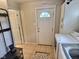 Laundry room with a washer, dryer, storage cabinet, and an exterior door at 3015 Mckinley Ave, Columbus, IN 47201