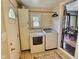 Laundry room with a washer, dryer, storage cabinet, and view to dining room at 3015 Mckinley Ave, Columbus, IN 47201
