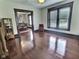 Spacious living room with gleaming hardwood floors, detailed trim, and an abundance of natural light at 3015 Mckinley Ave, Columbus, IN 47201