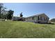 Large backyard with well-maintained lawn and brick home featuring a patio for outdoor enjoyment at 4511 W 300 S, Anderson, IN 46011