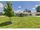 Well-maintained ranch-style home on a spacious lot with mature trees and manicured lawn at 4511 W 300 S, Anderson, IN 46011