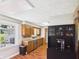 Charming kitchen with stainless steel appliances, wood cabinets, dark hardware, and a window overlooking the yard at 4511 W 300 S, Anderson, IN 46011
