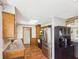 Well-lit kitchen features wood cabinets, stainless steel appliances, black cabinets and hardwood floors at 4511 W 300 S, Anderson, IN 46011