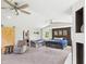 Spacious bedroom featuring a fireplace, accent wall, multiple windows, and neutral decor, with sitting area at 4511 W 300 S, Anderson, IN 46011