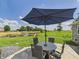 Outdoor patio space with a table, chairs, and umbrella, perfect for enjoying the beautiful scenery at 4511 W 300 S, Anderson, IN 46011