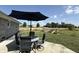 Outdoor patio features a dining area and scenic views of the backyard with play equipment at 4511 W 300 S, Anderson, IN 46011