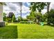 View of backyard featuring a playset and large grassy area with green lawn at 4904 N Washington Blvd, Indianapolis, IN 46205