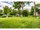 View of backyard featuring large grassy area, green fence, and a playset at 4904 N Washington Blvd, Indianapolis, IN 46205